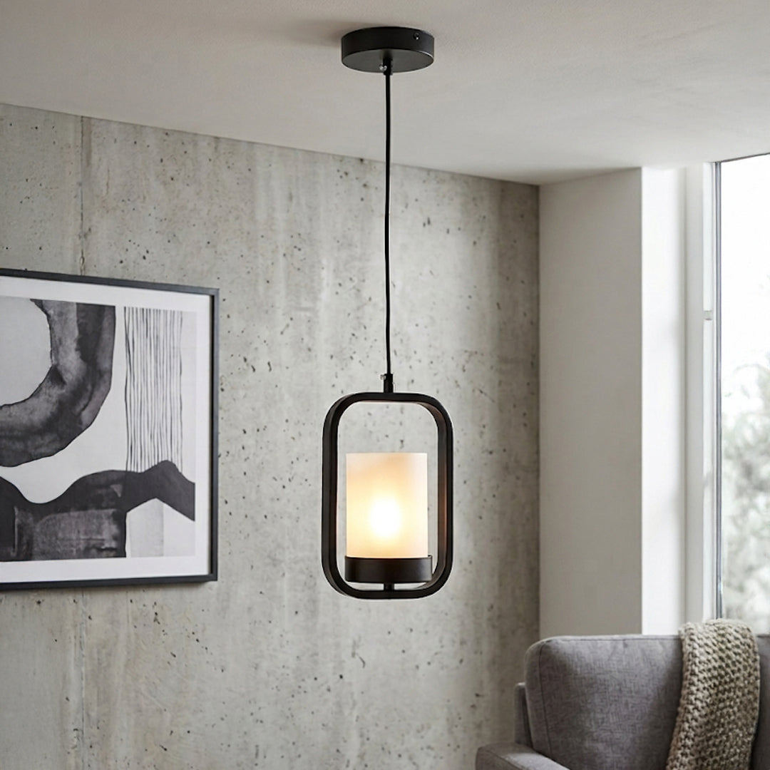 Textured clear glass and gold metal pendant light creating warm ambience in modern living interiors.