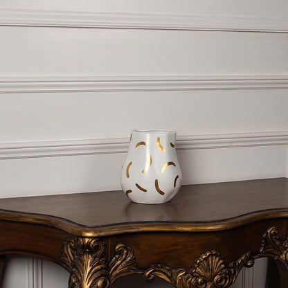 White ceramic decorative vase with gold abstract pattern styled on a vintage console table for elegant home decor.