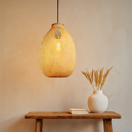 Modern black metal cone pendant light with a light wood top hanging in a cozy grey living room corner above a wooden side table.