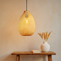 Handwoven rattan pendant light with natural beige finish creating warm cozy ambiance in modern interiors.