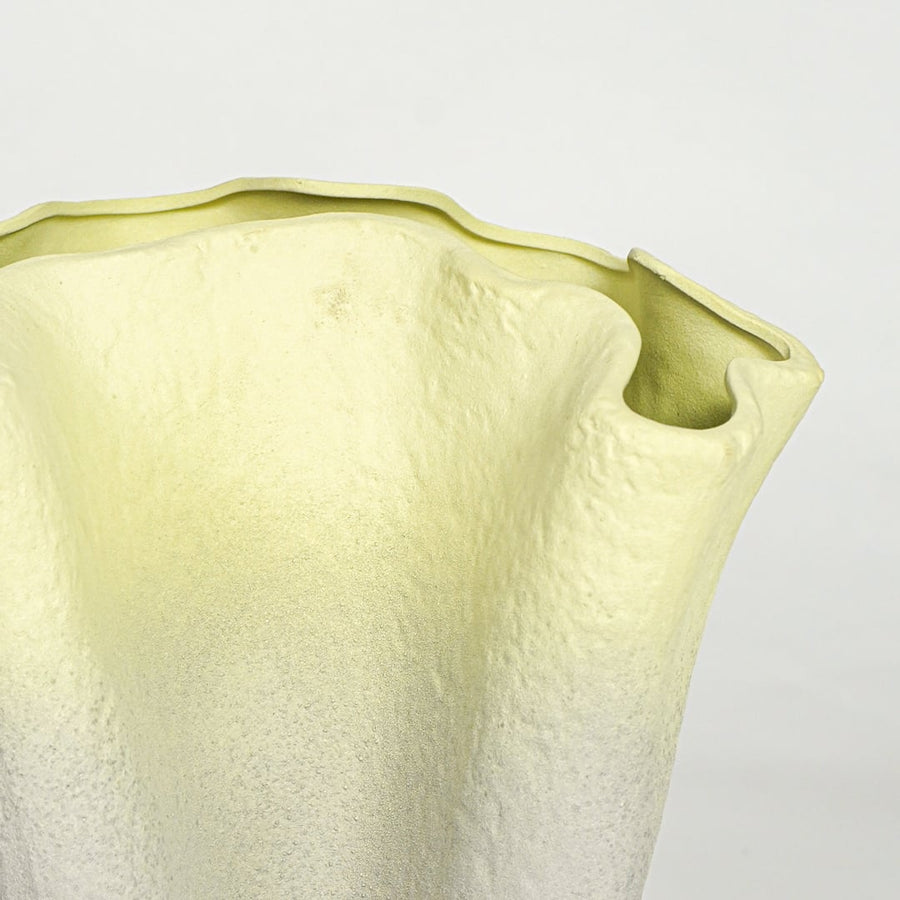 Close view of green gradient ceramic vase showing textured surface and sculpted rim detail for console or floor placement.