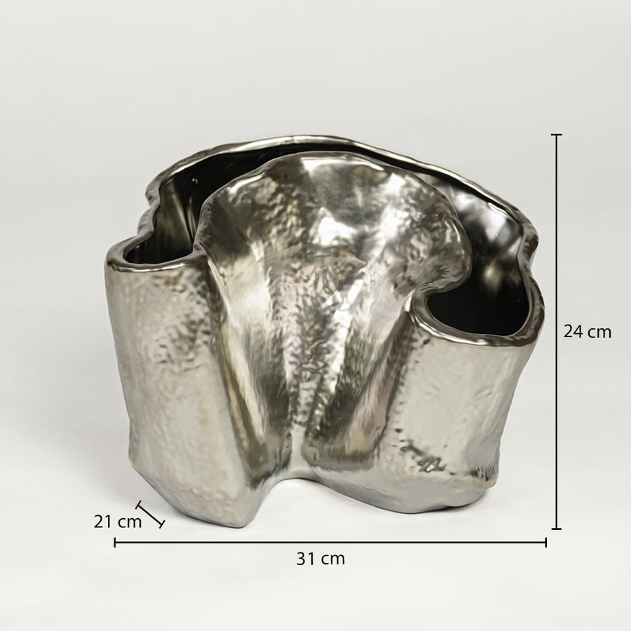 Silver metal decorative vase measuring 24 cm height 31 cm width and 21 cm depth ideal for modern table decor styling.