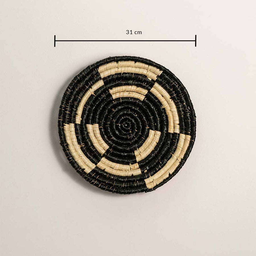 Dimension image of handcrafted black cream seagrass wall basket with concentric ring block pattern for boho wall decor.