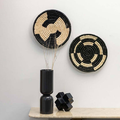 Handcrafted black and cream seagrass wall basket set with modern geometric patterns in lifestyle artisan home decor setup.