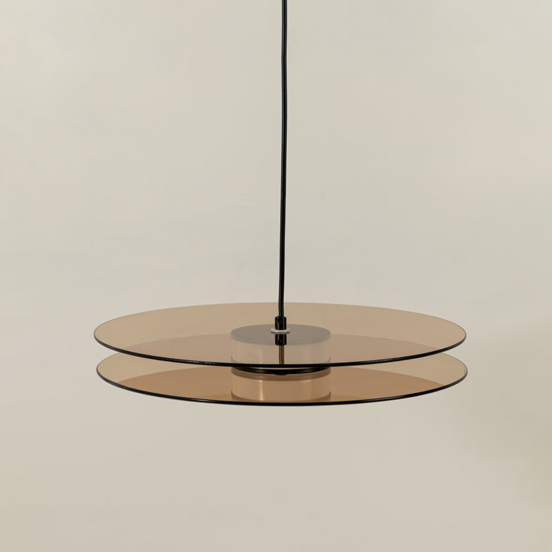 Minimalist brown wood and brass metal pendant light with layered design for elegant interiors.