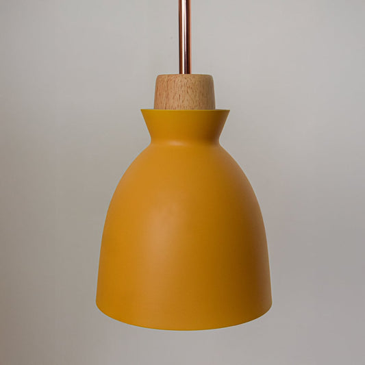 Closeup of yellow metal pendant light showcasing matte finish curved shade wooden cap and minimalist ceiling design.