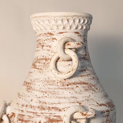 Close-up of tall chain vase showing intricate handmade chain links and distressed ceramic detailing.