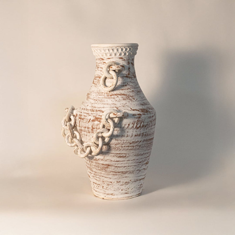Rustic tall chain vase displayed on white background highlighting handcrafted ceramic texture and sculptural chain detail.