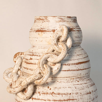 Close-up of large chain vase showing handcrafted ceramic links and natural textured surface details.