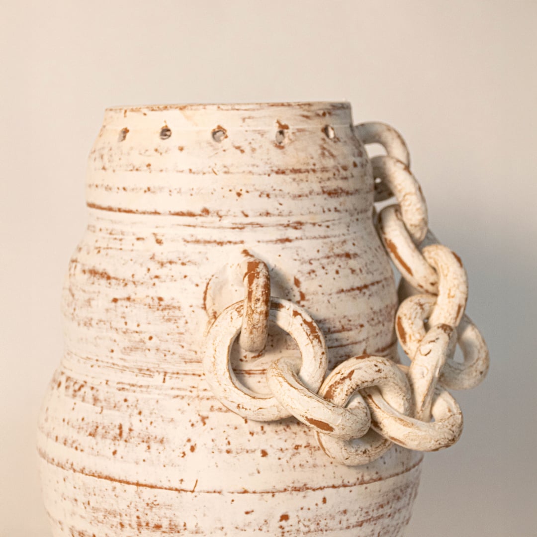 Close-up view of chain vase showing intricate ceramic chain links and distressed hand-painted texture.
