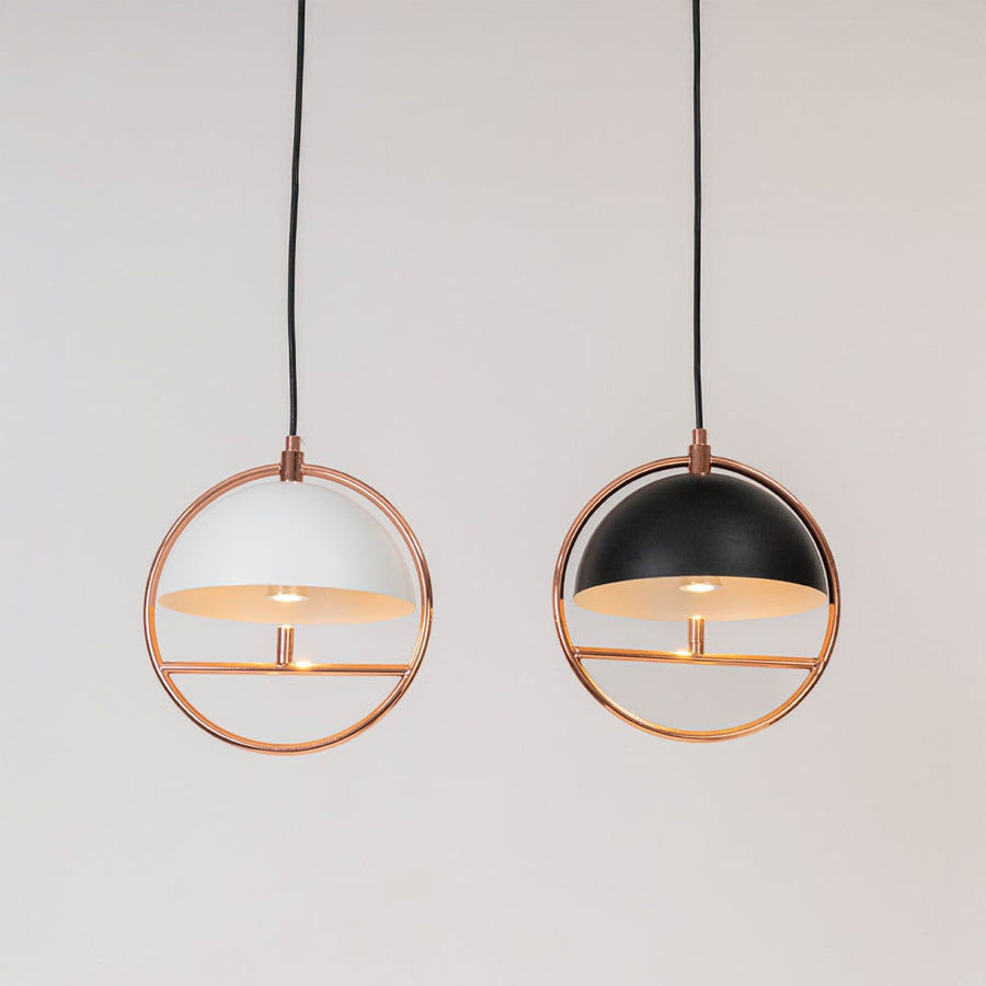 Set of pendant ceiling lamps in black and white dome shades with golden frame design for modern home interior lighting.
