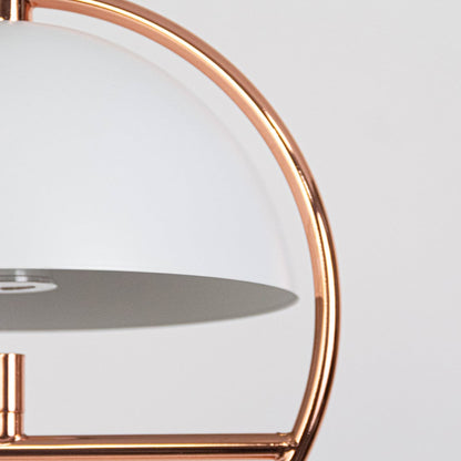 Closeup of rose gold pendant light featuring semi dome shade and circular metal frame with premium finish.