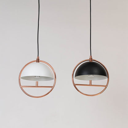 Pair of rose gold pendant ceiling lights with black and white dome shades displayed switched off.