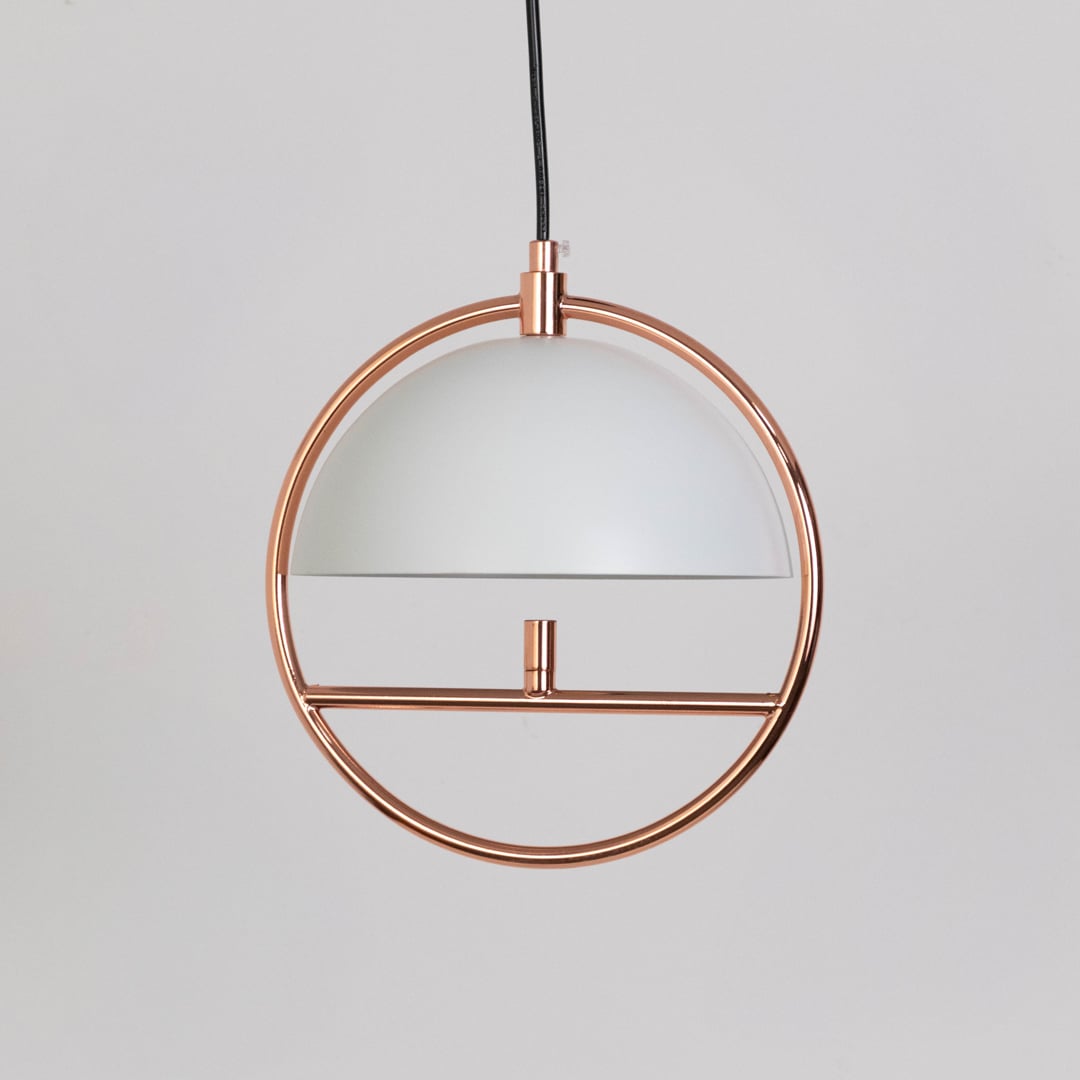 Rose gold pendant light with semi dome shade and circular frame shown turned off on white background.