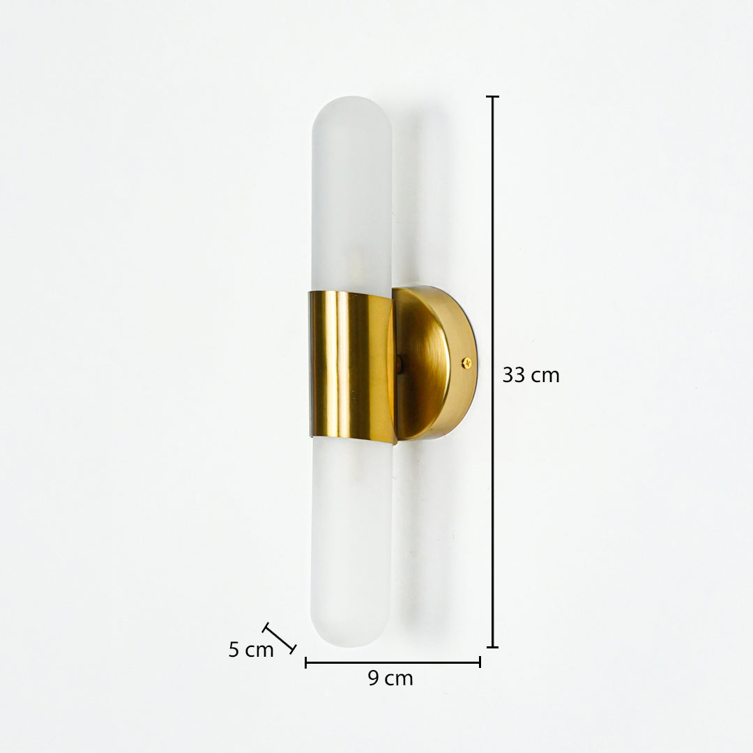 Modern wall light with frosted cylindrical glass and gold metal base mounted on neutral wall background 33 cm height 9 cm width 5 cm depth ideal for contemporary interior lighting.