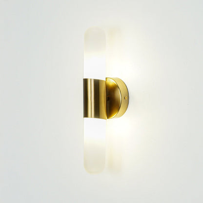 Gold wall light with vertical frosted glass tube mounted on neutral wall background ideal for modern bedroom or hallway lighting.