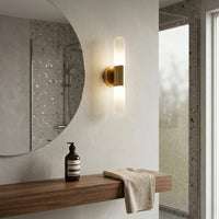 Stylish wall sconce with black glass shade and gold arm installed beside mirror in modern bathroom setting ideal for ambient lighting.

