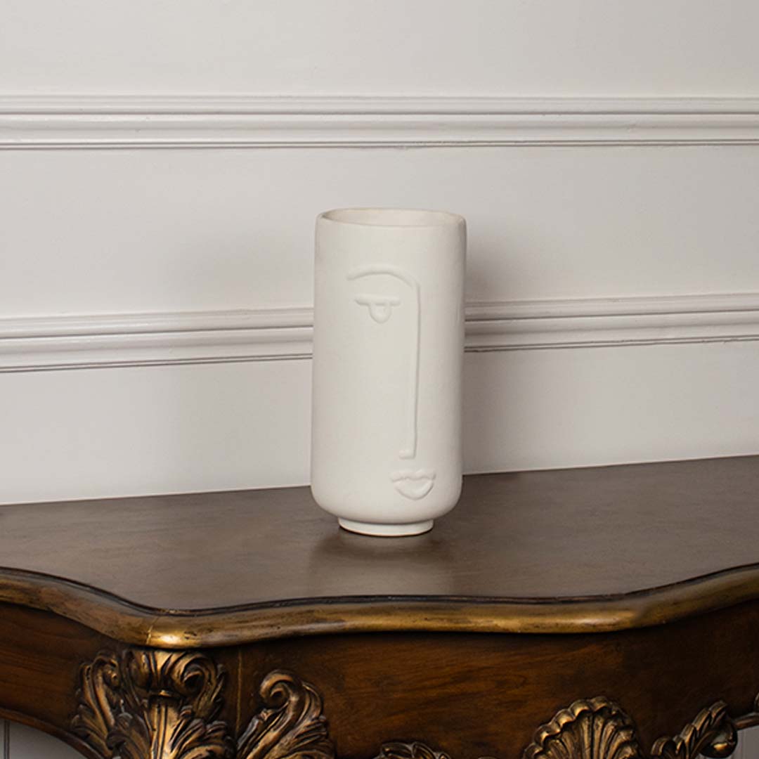 Tall white ceramic face vase shown on a clean white background highlighting its smooth finish and modern artistic design for tabletop decor.