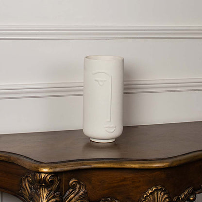Tall white ceramic face vase shown on a clean white background highlighting its smooth finish and modern artistic design for tabletop decor.