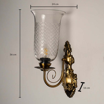 Antique brass wall sconce measuring 36 cm in height and 24 cm in width with 16 cm depth displayed on a white background.