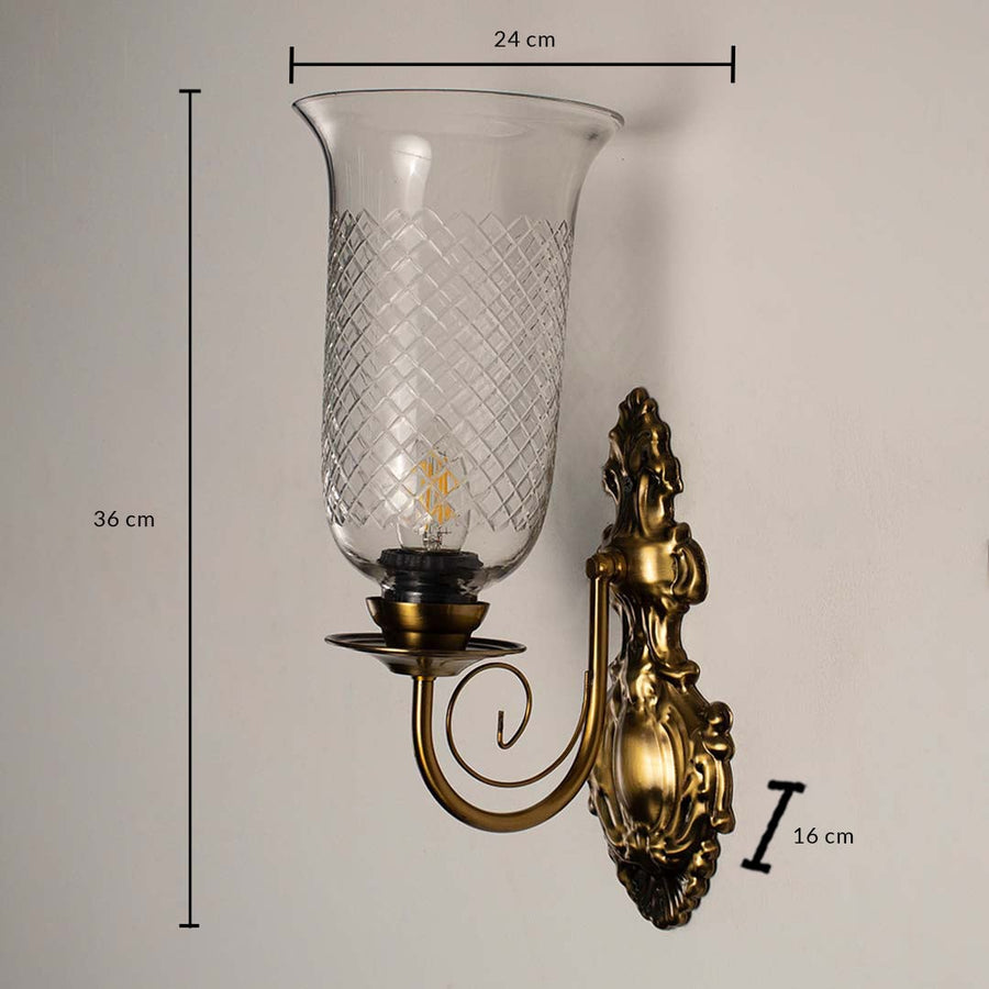 Antique brass wall sconce measuring 36 cm in height and 24 cm in width with 16 cm depth displayed on a white background.