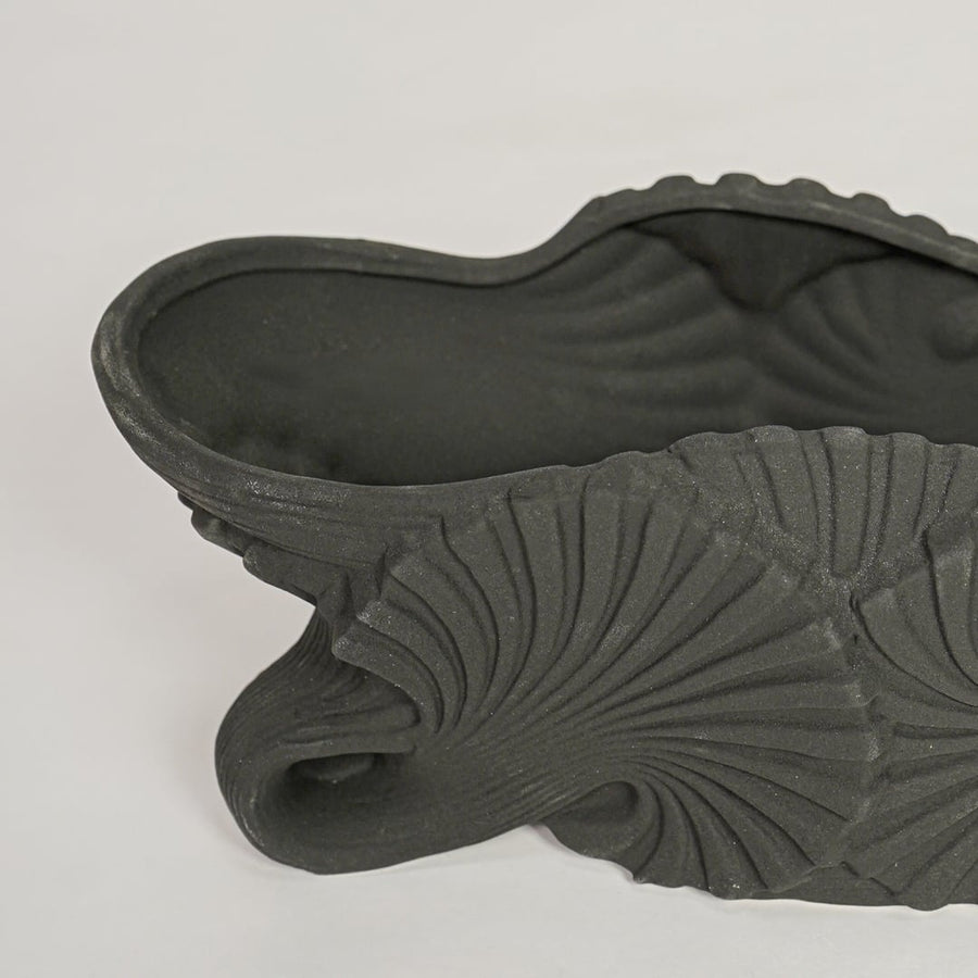 Black ceramic decorative shell bowl showing detailed sculpted texture perfect for elegant dining table centerpiece and console decor.
