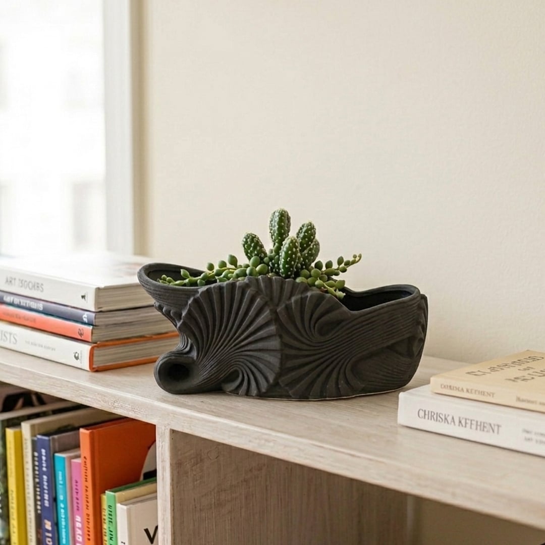 Modern black ceramic shell shaped decorative bowl styled as artistic centerpiece for dining table console table and living room decor.
