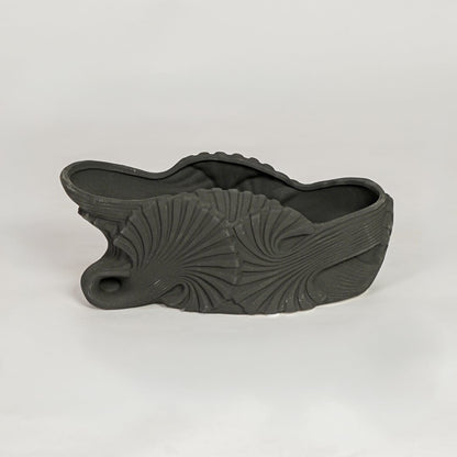 Black ceramic sculpted shell design decorative bowl ideal for fruit display dining table centerpiece and contemporary home decor styling.