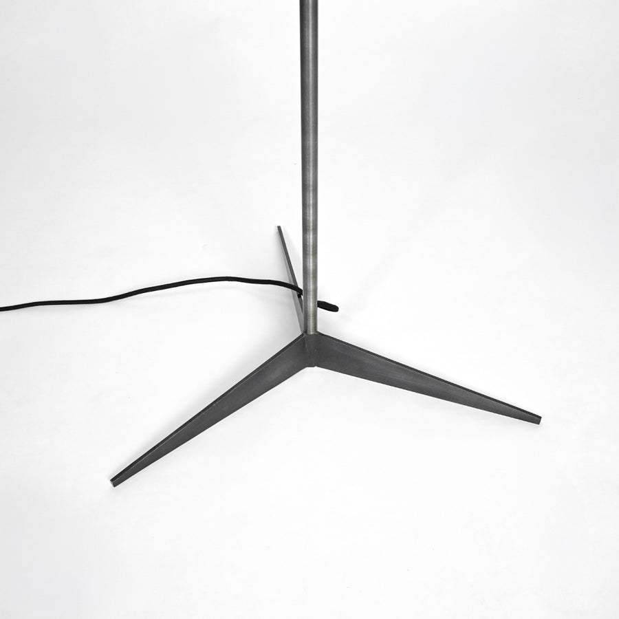 Black metal table lamp with wide dome shade for bedroom bedside table and home decor on white background image.