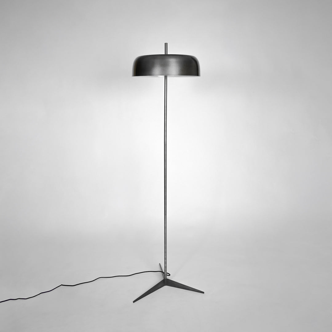 Modern black metal floor lamp with fabric shade for bedroom living room corner on white background image.