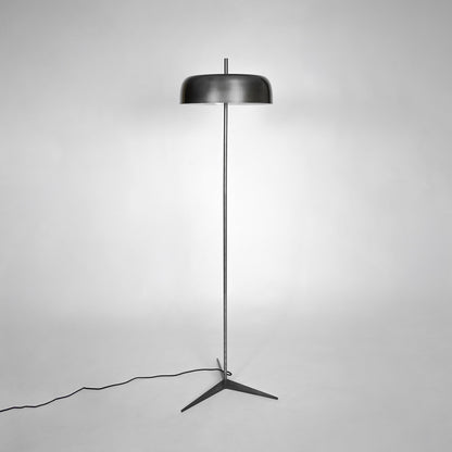 Modern black metal floor lamp with fabric shade for bedroom living room corner on white background image.