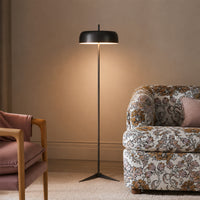 Modern black metal floor lamp with fabric shade for bedroom living room corner and cozy ambient lighting display.