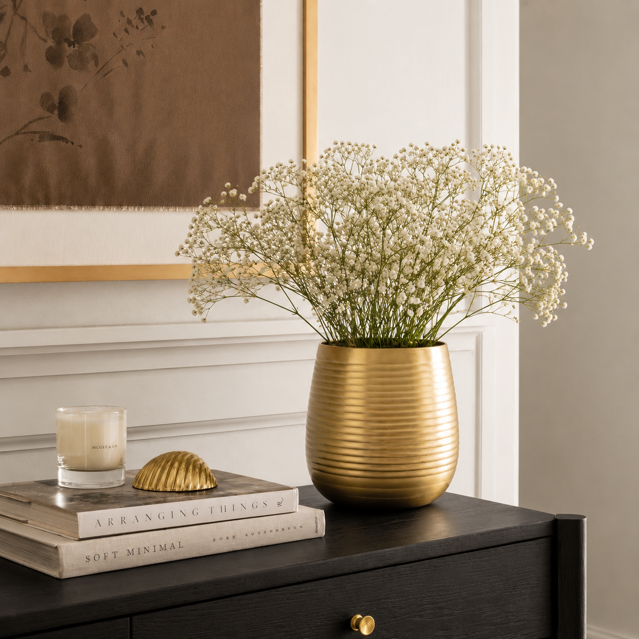 Lifestyle image of large gold hymn metal vase for elegant living room decor styling and modern home interior decoration.
