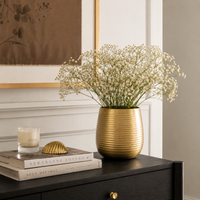 Lifestyle image of large gold hymn metal vase for elegant living room decor styling and modern home interior decoration.