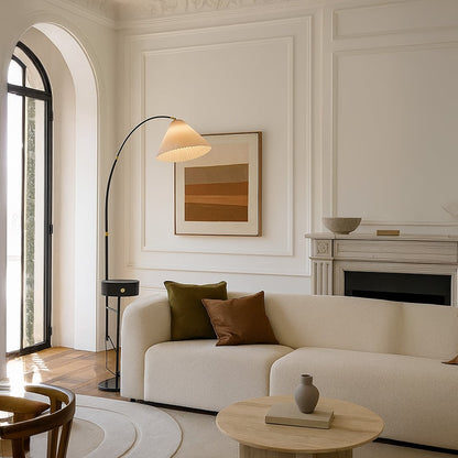 Modern arc floor lamp with metal body and warm shade placed beside sofa adding soft ambient lighting to elegant living room decor.