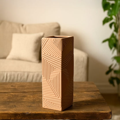 A tall textured brown geometric vase styled on a wooden surface creating a warm decorative accent that enhances modern interior settings.