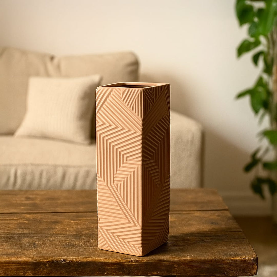A tall textured brown geometric vase styled on a wooden surface creating a warm decorative accent that enhances modern interior settings.