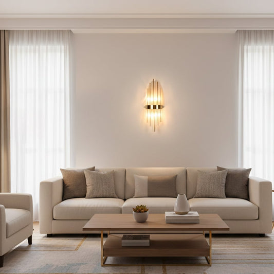Gold metal and clear crystal wall light styled on luxury interior wall creating dramatic vertical lighting for modern elegant homes.