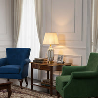 Classic table lamp with fabric shade placed on wooden side table creating warm balanced lighting for refined living room decor.