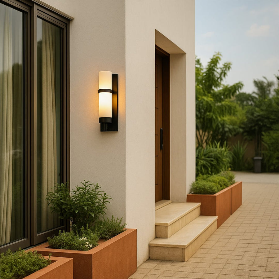 Modern black metal wall light with frosted glass shade styled on indoor wall for elegant home lighting decor.