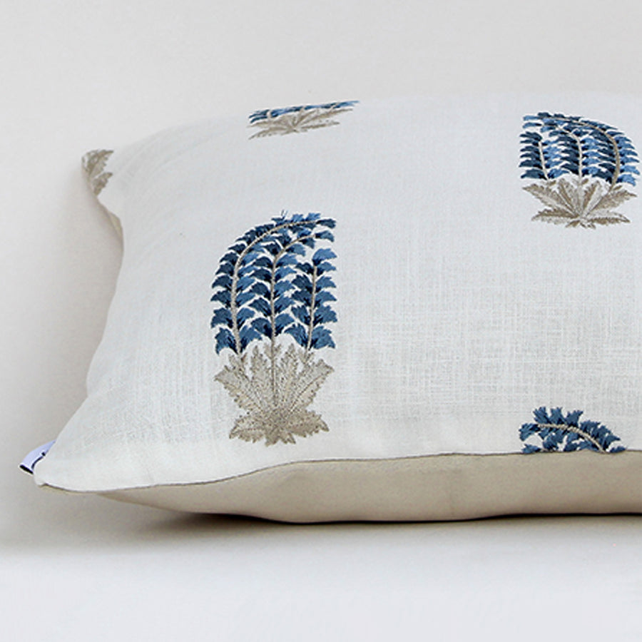 White cotton cushion cover with blue botanical print highlighting premium cotton fabric and concealed zipper detailing.