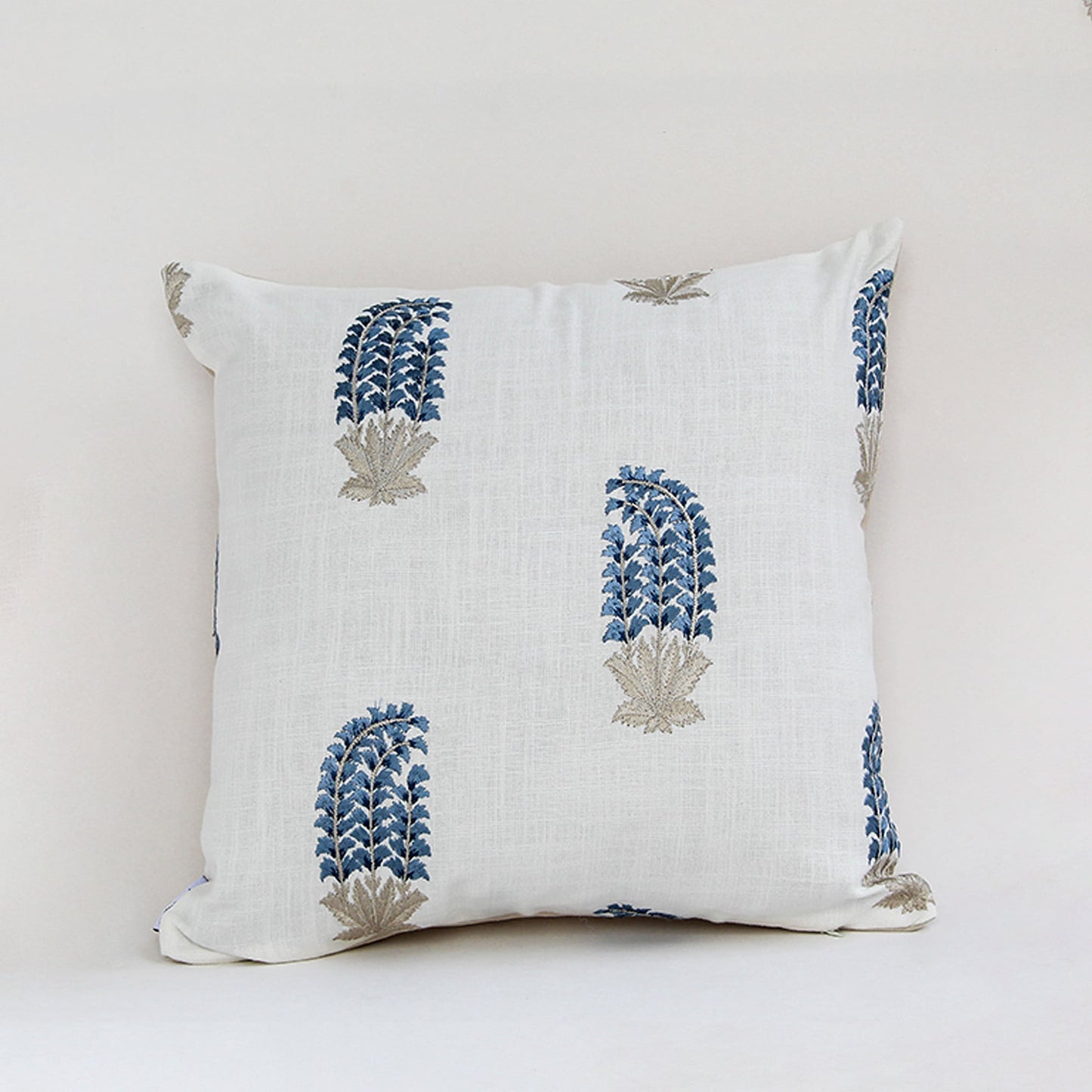 White cushion cover with blue handblock style floral print crafted in fabric ideal for sofa chair and bed decor styling.