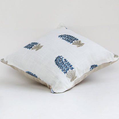 White cushion cover featuring repeating blue floral motifs smooth fabric finish and modern decorative cushion design on white background.
