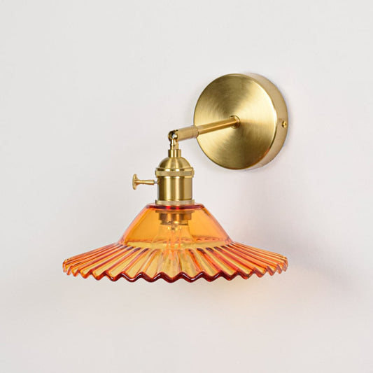 Amber ribbed glass wall light with gold metal base light off on white background ideal for bedroom living room wall decor.