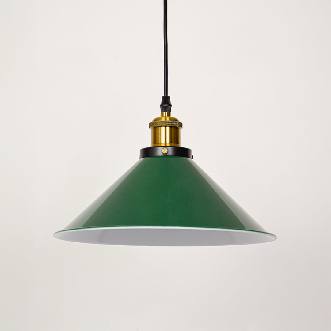 Green metal pendant light with brass holder displayed on white wall background perfect for elegant home interior decor.