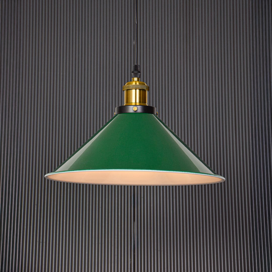 Modern green pendant lamp glowing warmly on black background creating cozy ambience for dining or bar area decor.