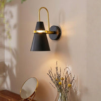 Lifestyle image of industrial loft gold and black wall sconce for elegant hallway decor styling and modern home lighting.