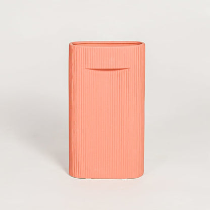 Contemporary coral ceramic flower vase with minimalist sculpted design perfect for entryway table living room decor display.