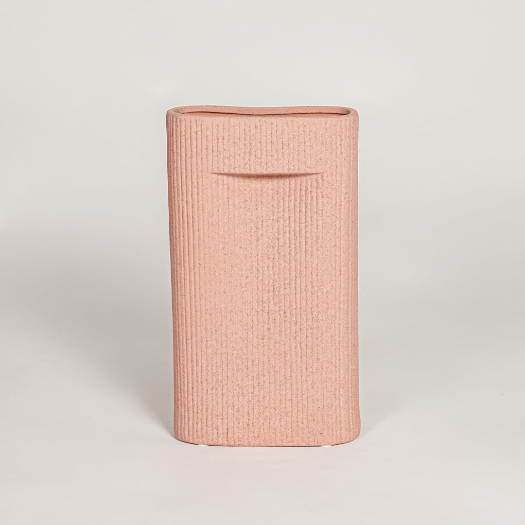 Contemporary peach ceramic flower vase with minimalist sculpted design perfect for entryway table living room decor display.