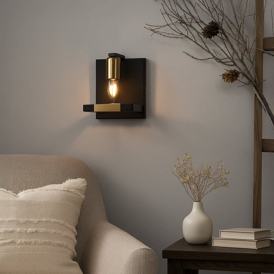 Wall mounted light in black metal with glass shade placed above sofa adding soft ambient lighting and modern character to interior decor.